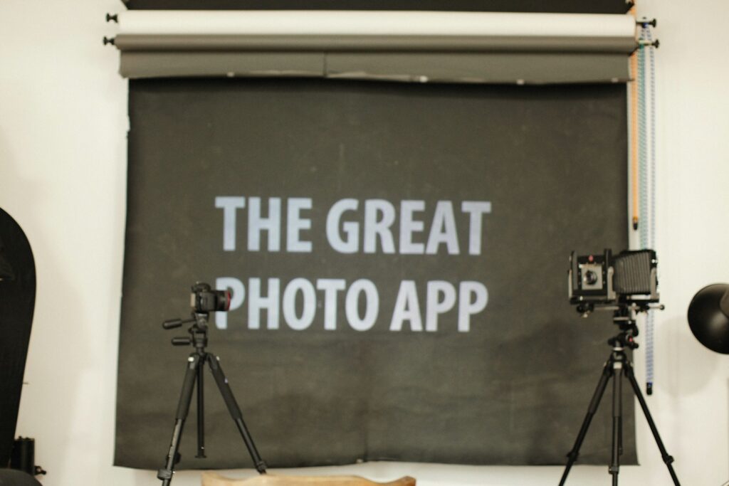 a camera and tripod set up in front of a sign